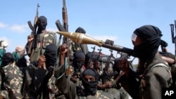 FILE - Armed al-Shabab fighters ride on pickup trucks just outside the Somali capital of Mogadishu, Dec. 8, 2008. The group said on Dec. 26, 2024, that one of its top commanders was killed in a drone strike in Somalia.