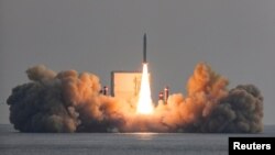 A solid-fuel space rocket is launched during a test flight over the sea near Jeju Island, South Korea, Dec. 4, 2023. (The Defense Ministry/Handout via Reuters)