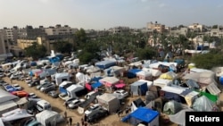 FILE - Displaced Palestinians, who fled their homes amid an Israeli offensive, shelter in tents in Khan Younis, in the southern Gaza Strip, Nov. 19, 2023.