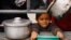 A Palestinian child waits to receive food cooked by a charity kitchen amid shortages of food supplies in Rafah, a city in the southern Gaza Strip, on February 13, 2024. (Ibraheem Abu Mustafa/Reuters)