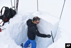 Doug Chabot, with the Gallatin National Forest Avalanche Center, isolates a column of snow to test the potential for avalanches in the area of Lulu Pass near Cooke City, Montana, Jan. 29, 2024.