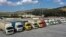 FILE - U.N. trucks with humanitarian aid for Syria following a devastating earthquake are parked at Bab al-Hawa border crossing with Turkey, in Syria's Idlib province, Feb. 10, 2023.