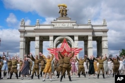 FILE - Moscow students dressed in the fashion of the middle of the last century and Soviet style uniform perform "Victory Waltz" as a part of Victory Day celebration, Moscow, May 6, 2023.