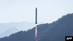FILE - A Long March-2C rocket, carrying the Einstein Probe satellite, lifts off from the Xichang Satellite Launch Center in Xichang in China's Sichuan province, Jan. 9, 2024. The head of the U.S. space agency said China is using its civilian program to mask military objectives.