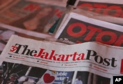 FILE - Copies of newspaper The Jakarta Post are seen at a news stand in Jakarta, Indonesia, Aug. 28, 2020.