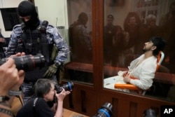 FILE - Mukhammadsobir Faizov, a suspect in the Crocus City Hall shootings, sits in Basmanny District Court in Moscow, Russia, on March 24, 2024. Four suspects in the attack appeared in court showing signs of brutal treatment while in custody.