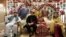 Groom Asher Khan and bride Dua Khan pose for a photo with family members during their wedding at Radiance hall in Karachi, Pakistan, Jan. 27, 2024.