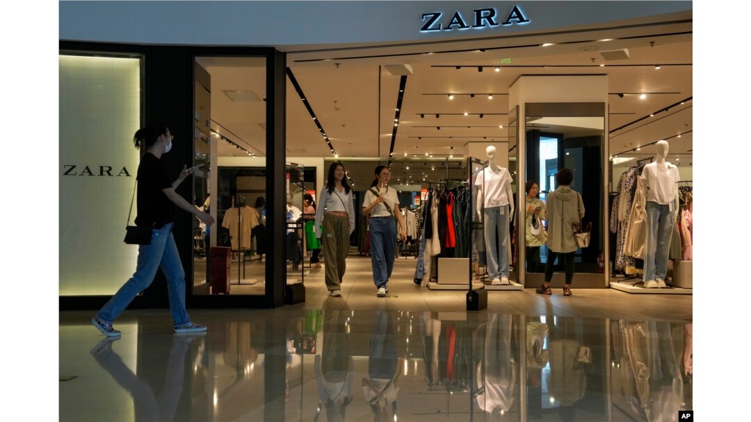 People are seen in a ZARA flagship store at a shopping mall in Beijing, June 21, 2023.