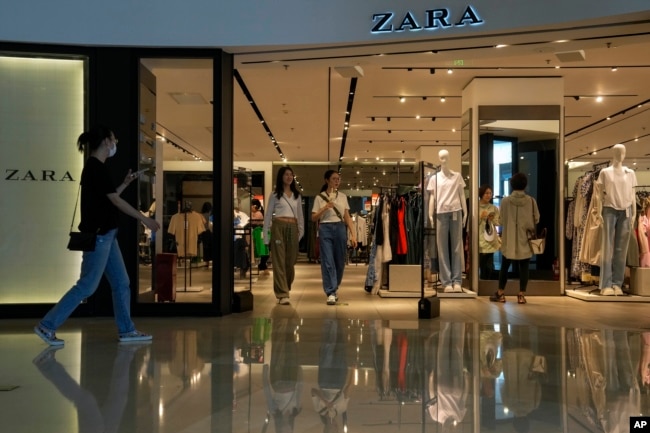 People are seen in a ZARA flagship store at a shopping mall in Beijing, June 21, 2023.