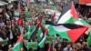 FILE - Demonstrators carry flags and banners during a protest in support of Palestinians in Gaza, amid the ongoing conflict between Israel and the Palestinian Islamist group Hamas, in Amman, Jordan, March 22, 2024.