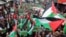 FILE - Demonstrators carry flags and banners during a protest in support of Palestinians in Gaza, amid the ongoing conflict between Israel and the Palestinian Islamist group Hamas, in Amman, Jordan, March 22, 2024.