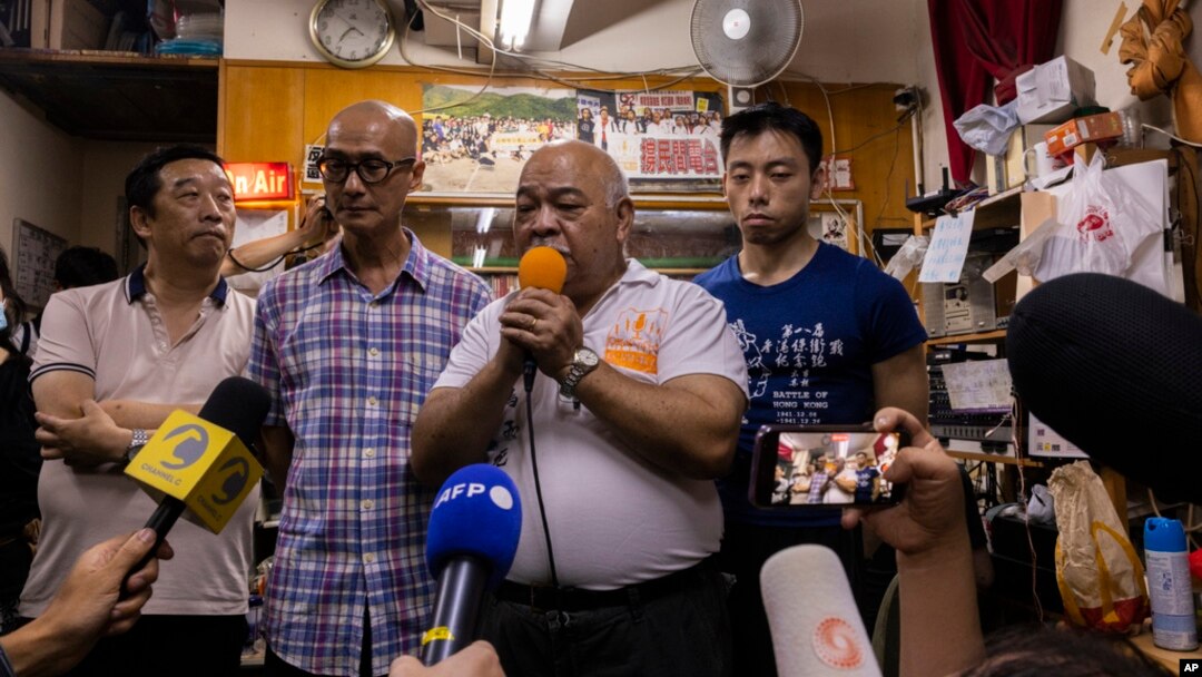 "The Bull," Tsang Kin-shing, center, founder of Hong Kong's pro-democracy Citizens' Radio station, along with station guests, speaks to reporters prior to the station's last broadcast in Hong Kong, June 30, 2023.