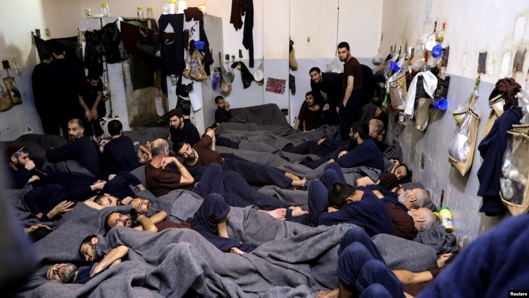 FILE - Foreign prisoners, suspected of being part of the Islamic State group, lie in a prison cell in Hasaka, Syria, Jan. 7, 2020.
