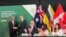 New Zealand PM Hipkins shakes hands with Malaysian Minister of Investment, Trade and Industry Tengku Abdul Aziz, as Britain signs the treaty to join the Comprehensive and Progressive Agreement for Trans-Pacific Partnership, in Auckland, July 16, 2023.