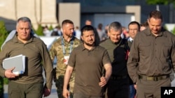 FILE - Ukraine President Volodymyr Zelenskyy, center, leaves after a news conference at the European Political Community (EPC) Summit in Bulboaca, near Chisinau, Moldova, June 1, 2023.