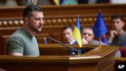 In this photo provided by the Ukrainian Presidential Press Office, Ukrainian President Volodymyr Zelenskyy addresses lawmakers during a Constitution Day session of the Ukrainian parliament in Kyiv, June 28, 2023. (Ukrainian Presidential Press Office via AP)