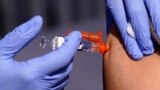 FILE - A patient gets a flu vaccine Oct. 28, 2022, in Lynwood, Calif. 