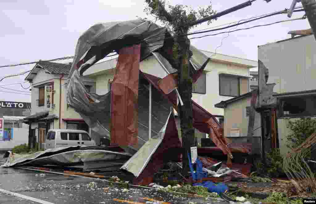 An object blown by strong winds caused by Typhoon Shanshan is stranded on a power line in Miyazaki, southwestern Japan, in this photo taken by Kyodo.