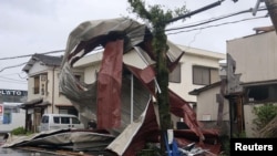 An object blown by strong winds caused by Typhoon Shanshan is stranded on a power line in Miyazaki, southwestern Japan, Aug. 29, 2024, in this photo taken by Kyodo.