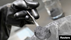 FILE - Graphite powder is pictured in a Volkswagen pilot line for battery cell production in Salzgitter, Germany, May 18, 2022. Beijing in December is set to curb exports of graphite, a key material used in the making of batteries for electric vehicles.