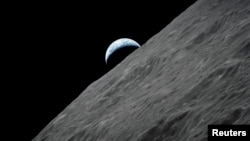 In this file photo, the crescent Earth rises above the lunar horizon in this undated NASA handout photograph taken from the Apollo 17 spacecraft in lunar orbit during the final lunar landing mission in the Apollo program in 1972. (REUTERS/NASA/Handout)