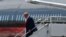 FILE: Former US President Donald Trump disembarks his personal aircraft at Miami International Airport in Miami, Florida, on June 12, 2023, a day before3 his arraignment on 37 federal felony charges.