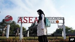 A pedestrian passes by a sign of the Association of Southeast Asian Nations in Jakarta, Indonesia, July 10, 2023. 