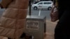 Women pass a sticker advertising abortion pills on a sidewalk in Johannesburg, South Africa, on June 28, 2023. Abortion policy and availability are among the issues that could be affected by the winner of the Nov. 5, 2024, U.S. presidential election.