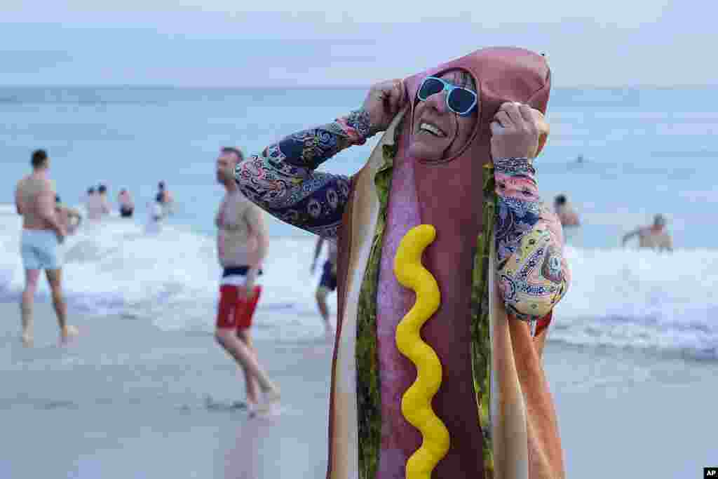 Christina Lusk of Fort Lauderdale adjusts her wet hotdog costume as she emerges from the ocean during a Groundhog Day celebration in Hollywood, Florida.