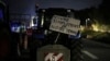 A sign on a tractor reads "live simply from our work" at a highway barricade in Aix-en-Provence, southern France, Jan. 30, 2024.