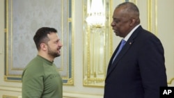 Ukrainian President Volodymyr Zelenskyy, left, and U.S. Secretary of Defense Lloyd Austin talk during their meeting in Kyiv, Ukraine, Nov. 20, 2023. (Ukrainian Presidential Press Office via AP)