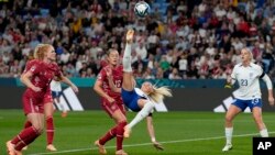 England's Chloe Kelly attempts a bicycle kick next to Denmark's Janni Thomsen during the Women's World Cup Group D soccer match between England and Denmark at the Sydney Football Stadium in Sydney, Australia, July 28, 2023.