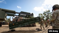 US soldiers load an Army Tactical Missile System (ATACMS) during an exercise in Queensland, Australia, July 26, 2023. Ukraine has asked the US to supply it with ATACMS, and the Biden administration is close to making a decision about the request.