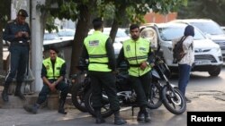 Iran's police forces stand on a street during the revival of morality police in Tehran, July 16, 2023. Authorities sealed an office in Tehran after the company posted pictures of female employees not wearing the hijab. (Majid Asgaripour/WANA (West Asia News Agency) via Reuters)