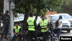 Iran's police forces stand on a street during the revival of morality police in Tehran, July 16, 2023. (Majid Asgaripour/WANA (West Asia News Agency) via Reuters)