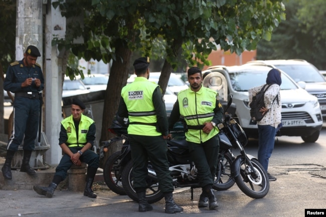 Iran's police forces stand on a street during the revival of morality police in Tehran, July 16, 2023. (Majid Asgaripour/WANA)