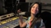 Viviam María López, en la cabina durante una emisión del programa 'Cubaneando with Viviam María' en la emisora WDNA 88.9 FM, en Miami, EEUU. [Foto: Cortesía de la entrevistada].