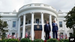 President Joe Biden and Japanese Prime Minister Fumio Kishida listen to the national anthem during an arrival ceremony on the South Lawn of the White House, April 10, 2024.