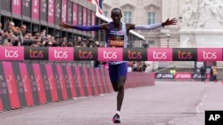 Kenya's Kelvin Kiptum crosses the finish line to win the men's race at the London Marathon in London, Sunday, April 23, 2023.