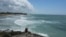 A man takes a video from the rocky shore of Mirador beach ahead of Hurricane Beryl's expected arrival, in Tulum, Mexico, July 4, 2024.