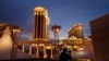 FILE - A man takes pictures of Caesars Palace hotel and casino in Las Vegas, Jan. 12, 2015.