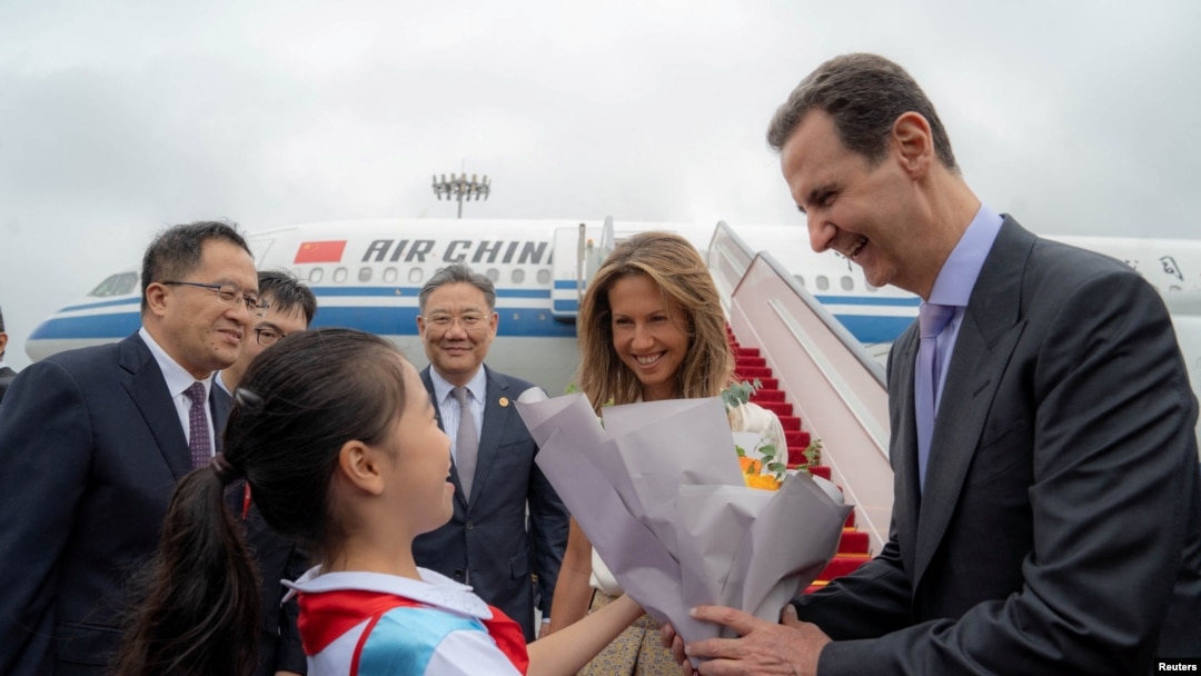 Syria's President Bashar al-Assad and his wife Asma are welcomed upon their arrival at Hangzhou airport, China, Sept. 21, 2023.