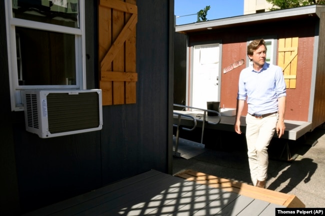 Denver Mayor Mike Johnston tours a micro community in the city on Wednesday, June 5, 2024. (AP Photo/Thomas Peipert)