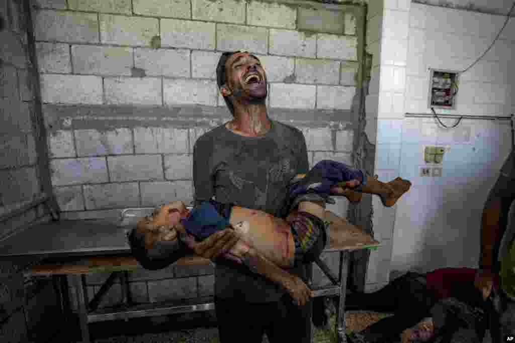 A Palestinian man mourns a relative killed in the Israeli bombardment of the Gaza Strip at a hospital morgue in Deir al-Balah.