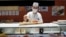 FILE - A sushi chef prepares a plate at the Toyosu Market, Jan. 29, 2024, in Tokyo.