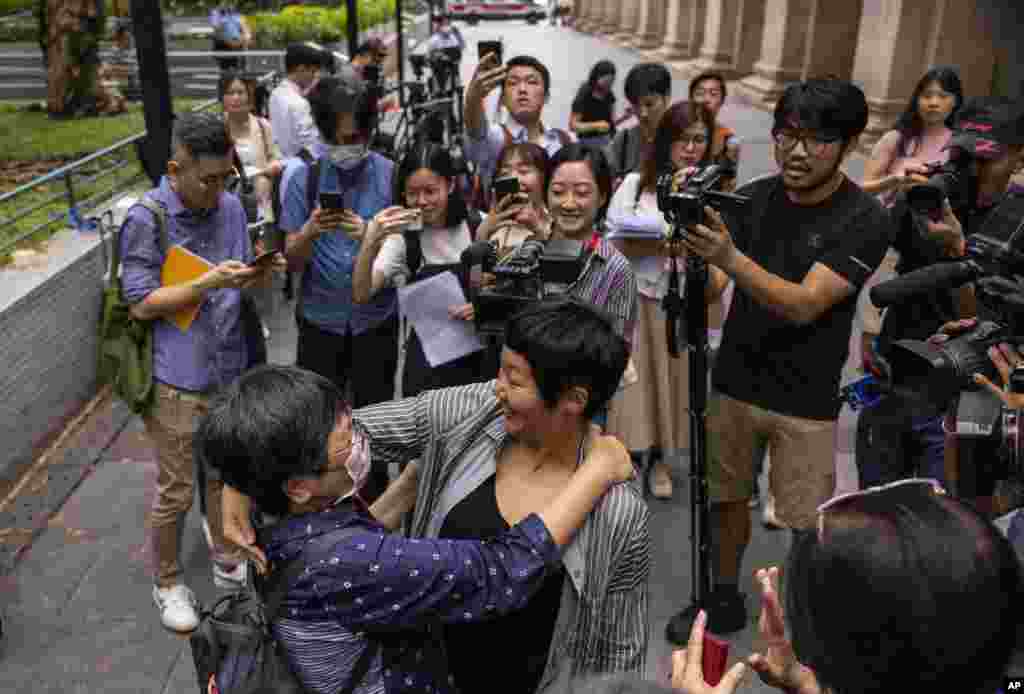 Award-winning Hong Kong journalist Bao Choy, front right, hugs Sham Yee-lan, former Hong Kong Journalists Association chairperson, after being cleared by the city&#39;s top court in Hong Kong.