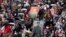 FILE - People attend the Immortal Regiment march through the main street toward Red Square marking the 77th anniversary of the end of World War II, in Moscow, Russia, May 9, 2022. 