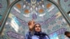 An Iranian woman gestures at a polling station in a snap presidential election to choose a successor to Ebrahim Raisi following his death in a helicopter crash, in Tehran, Iran, June 28, 2024. (West Asia News Agency via Reuters)