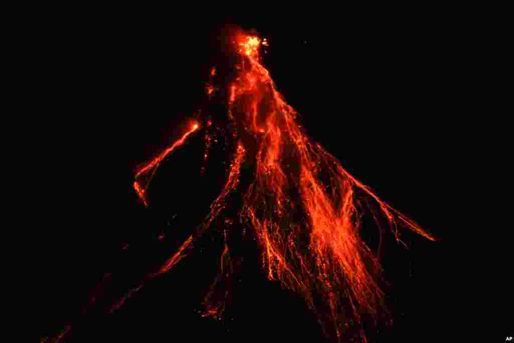 Lava flows down the slopes of Mayon volcano as seen from Legazpi, Albay province, northeastern Philippines, June 15, 2023.