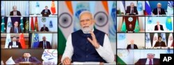 Indian Prime Minister Narendra Modi, center, addresses a virtual summit of the Shanghai Cooperation Organization, July 4, 2023. (India government's Press Information Bureau via AP)